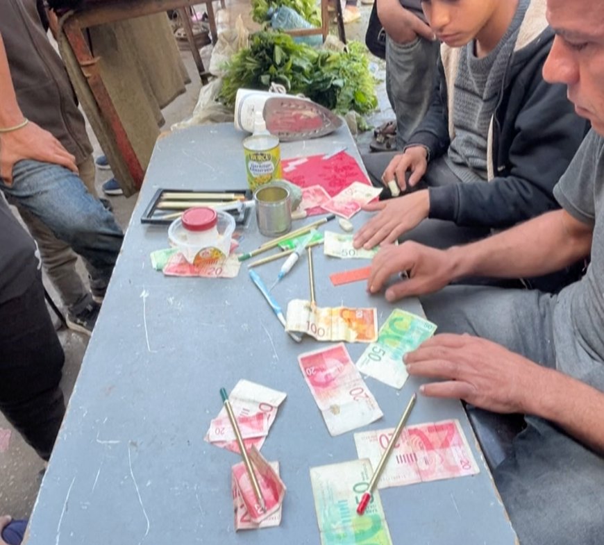 Poverty hit Palestinians repair banknotes in Gaza